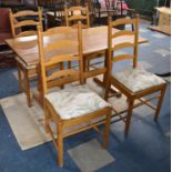 A Modern Rectangular Pine Kitchen Table and Four Ladder Back Chairs