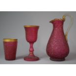 A Set of Three Continental Cranberry Glass Items to Include Jug, Goblet and Beaker, Jug 27cm high