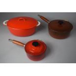 A Collection of Three French and Belgian Red Enamelled Cooking Pans with Lids