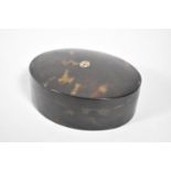 An Oval Tortoiseshell Dressing Table Box with Inlaid Gold Monogramme, C R O, 10.5cm Wide