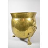 A Mid 20th Century Brass Cauldron Shaped Planter on Three Claw Feet with Lion Mask and Ring Carrying