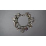 A Silver Charm Bracelet with 14 Charms Stamped 925