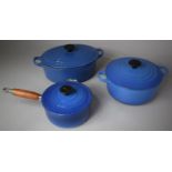 A Collection of Four French Blue Enamelled Cast Iron Cooking Pans with Lids