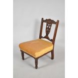 An Edwardian Mahogany Ladies Nursing Chair with Pierced Brass Splat