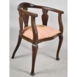 An Edwardian Mahogany Smokers Bow Armchair with Serpentine Front