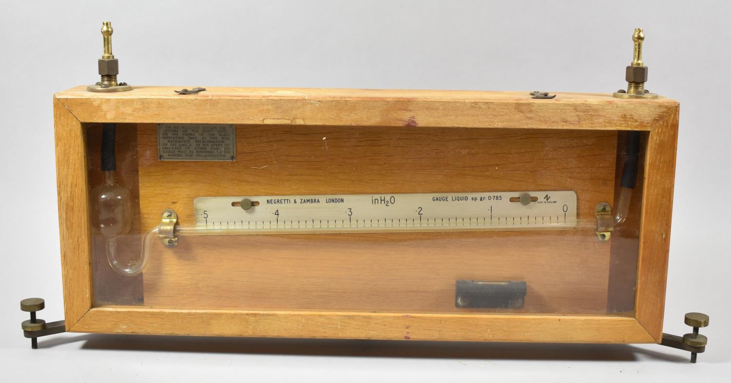 A Negretti and Zambra Spirit Level Gauge in Wooden Case, 56cm Wide