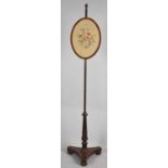 A Late 19th Century Mahogany Pole Screen with Triform Base and Rise and Fall Oval Tapestry Screen