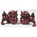 A Pair of Chinese Resin Temple Lions with Front Paws Guarding Flaming Pearls, Each 15cm Wide