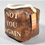 A Leather Effect Doorstop Cube, Inscribed "Not You Again"