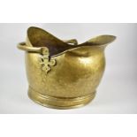 A Brass Helmet Shaped Coal Scuttle, 44cm Long