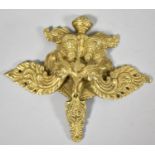A Gilt Metal Tibetan Mount in the Form of a Dragon Mask with Flame from Nostrils, 19cm wide and 17cm