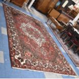 A Rectangular Patterned Woollen Rug, 317x209cm