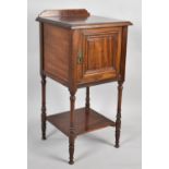 An Edwardian Mahogany Galleried Bedside Cabinet with Panelled Door, Stretcher Shelf and Turned