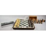 A Folding Plastic Chessboard and Piece Set, a Box Wood Small Set of Chess Pieces and a Cased Set