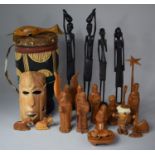 A Collection of Carved Items to Include Nativity Figures, Souvenir Masks, African Drum etc