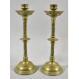 A Pair of Arts and Crafts Brass Candlesticks with Twisted Stems, 26.5cm high