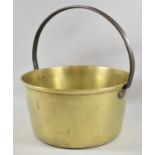 A Large and Heavy Brass Jam Kettle with Iron Loop Handle, 33cm Diameter