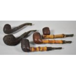 A Collection of Three Bamboo Stemmed Pipes and Two Carved Pipes, One with Silver Band