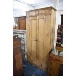 A Stripped Pine Hanging Wardrobe with Base Drawer, 95cm wide