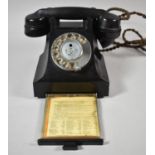 A Vintage Black Bakelite Telephone with Pullout Number Drawer