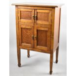 An Edwardian Oak Cabinet with Two Pairs of Panelled Doors to Shelved Interior