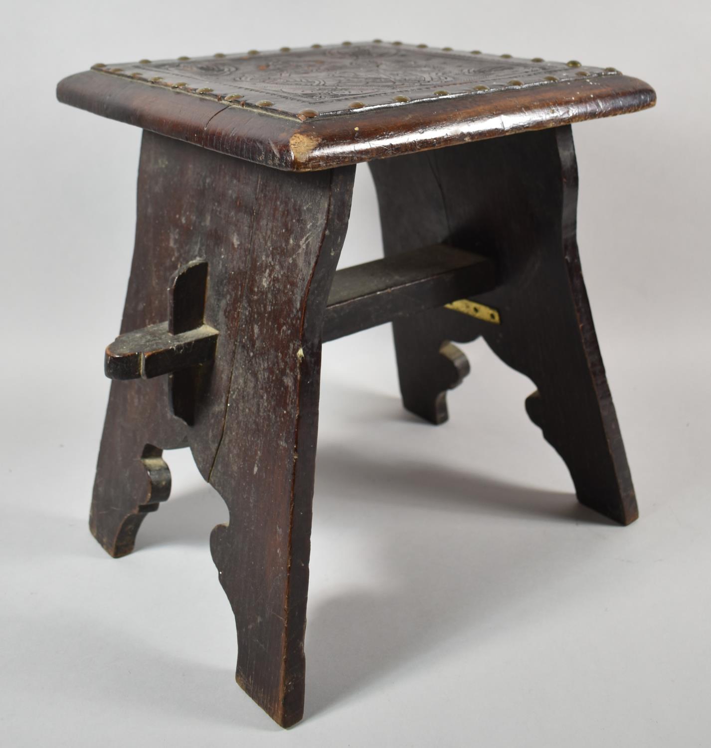 A Square Topped Tooled Leather Mounted Country Stool with Brass Studwork and Armorial Design, 34.5cm