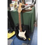 A Squier Strat Guitar and a Peavey Rage 158 Amp