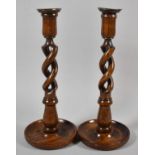 A Pair of Edwardian Carved Oak Spiralled Candle Sticks on Circular Bases, 30cm high