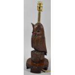 A Black Forest Carved Wooden Table Lamp in the Form of an Owl with Glass Eyes, 43cm high