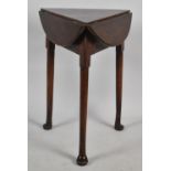 A 19th Century Mahogany Twist Top Drop Leaf Triangular Table on Cricket Supports