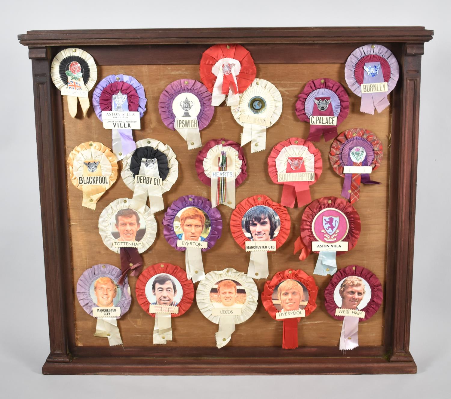 A Framed Wooden Noticeboard with Souvenir Football Club Rosettes, 104cm wide