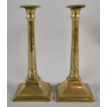 A Pair of Brass Column Candle Sticks of Reeded Tapering Form on Square Bases, 26cm high