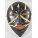 A Carved Wooden Tribal Face Mask with Painted Decoration, 30cm high