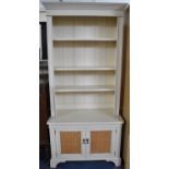 A White Painted Laura Ashley Bookcase with Three Adjustable Shelves and Cane Panelled Doors to