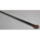 An Ebonised Tapering Walking Cane with Globular Handle, 90cm Long