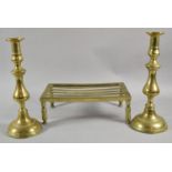 A Brass Rectangular Trivet and Pair of 19th Century Brass Candlesticks, 30cm high