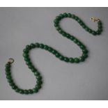 A String of Circular Jade Beads, 41cm Long