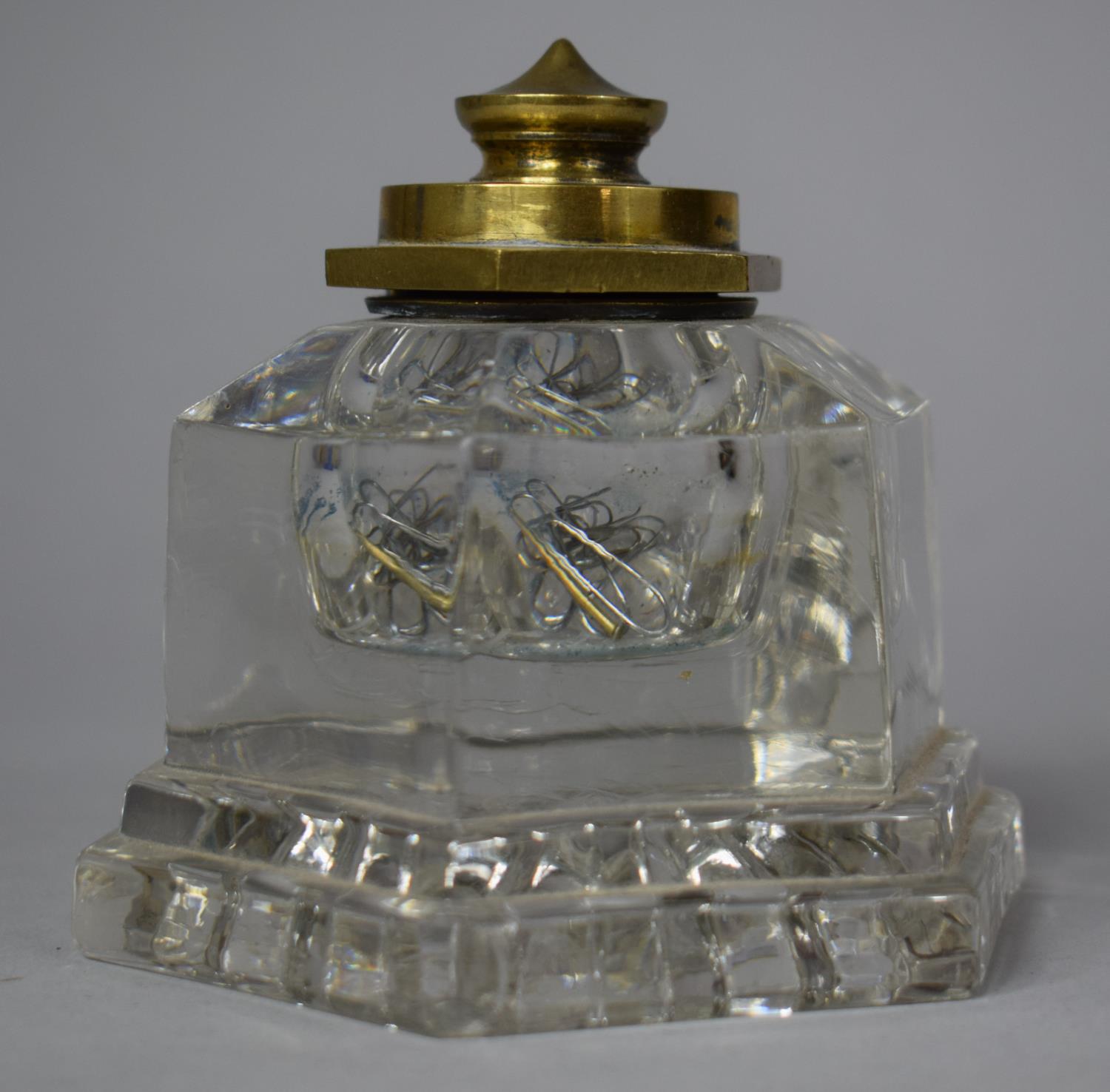 A Brass Mounted Hexagonal Glass Desktop Inkwell, 9.5cm high