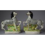 A Pair of 20th Century Staffordshire figures of Zebra, Each 21cm high (AF)