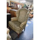 A Modern Upholstered Wing Armchair on Short Cabriole Front Legs