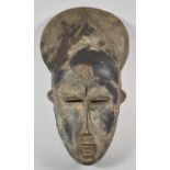 A West African Carved Tribal Mask, Ivory Coast, 34cm high