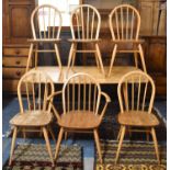 An Ercol Rectangular Dining Table and Six Dining Chairs Including One Carver