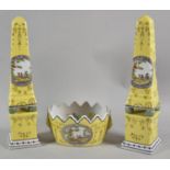 A Pair of Continental Obelisks and Wavy Rimmed Bowl All Decorated with Circular Cartouches Depicting
