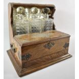A Late 19th Century Silver Plate Mounted Three Bottle Games Tantalus with Hinged Lid to Games