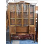 An Edwardian Inlaid Mahogany Breakfront Display Cabinet with Glazed Quadrant Doors Over Open Display