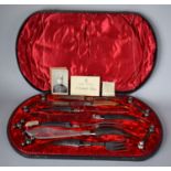 A Cased Silver Plate and Antler Double Carving Set with Fish Servers, Two Pairs of Knife Rests
