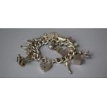 A Silver Charm Bracelet with Silver and White Metal Charms, Total Weight 85.2g