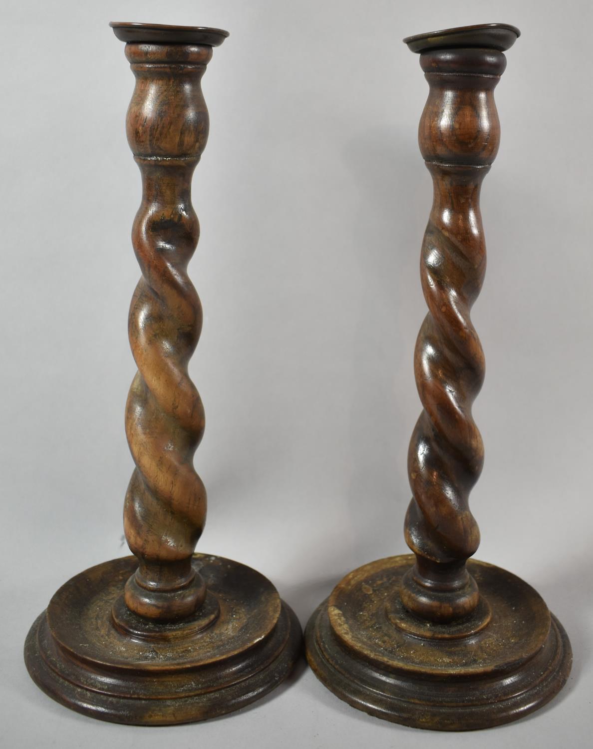 A Pair of Edwardian Oak Barley Twist Candlesticks on Circular Bases, 32cm high