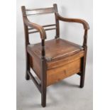 An Edwardian Commode Armchair