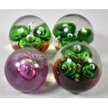 A Collection of Four Glass Paperweights